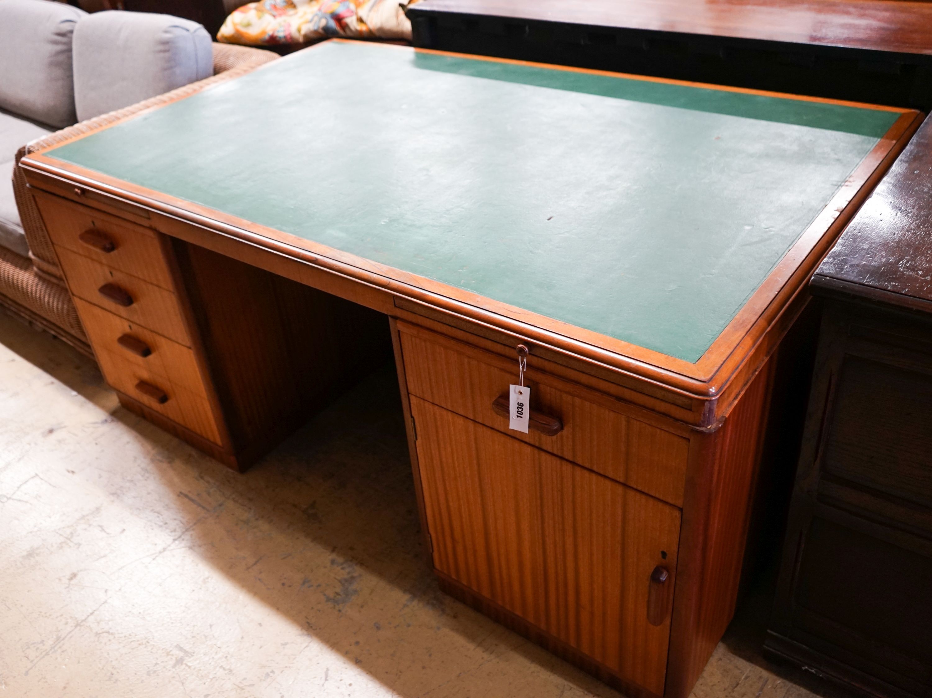 A mid century design teak kneehole desk, bears a Waring & Gillow stamp, length 168cm, depth 106cm, height 74cm